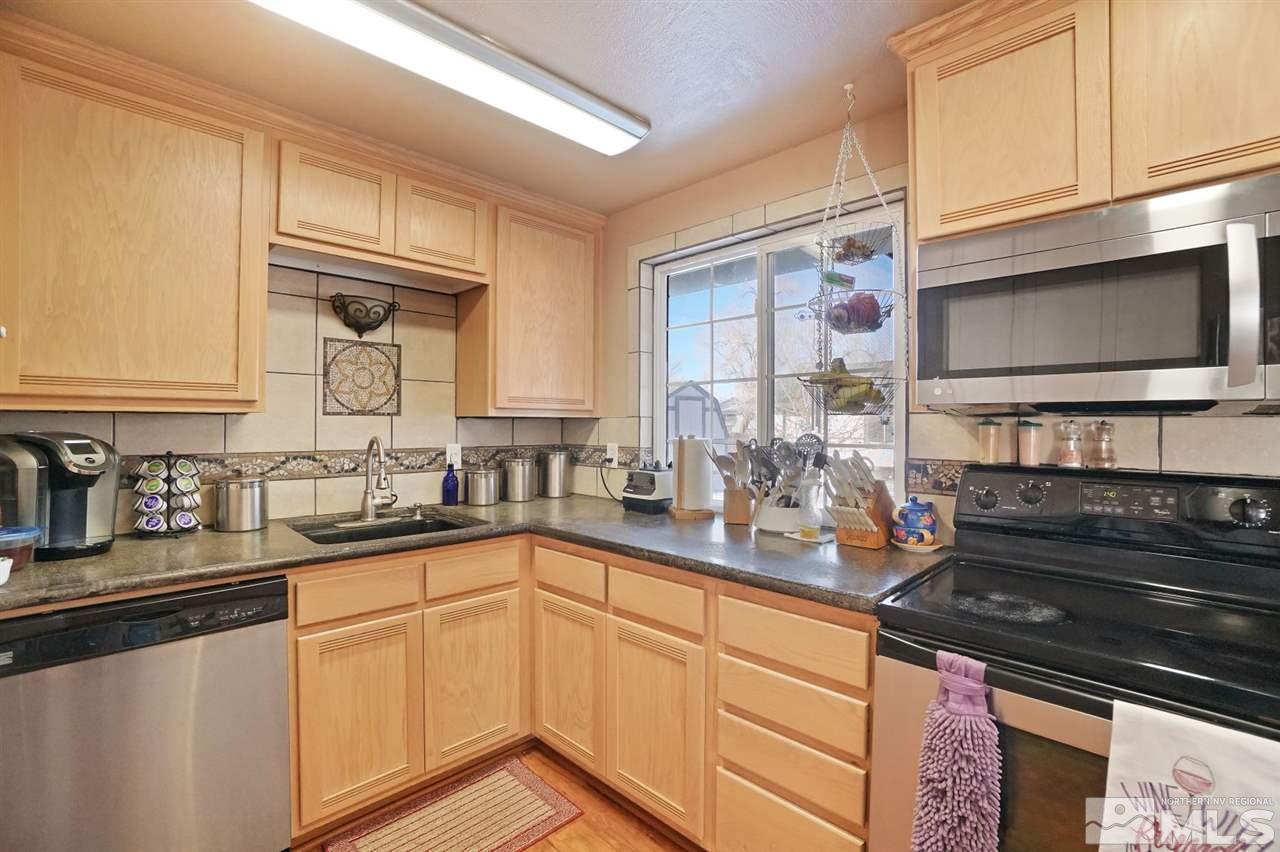 3800 Alcorn Road Fallon, NV 89406 - Photo 6 of 18 a kitchen with stainless steel appliances granite countertop a sink and cabinets