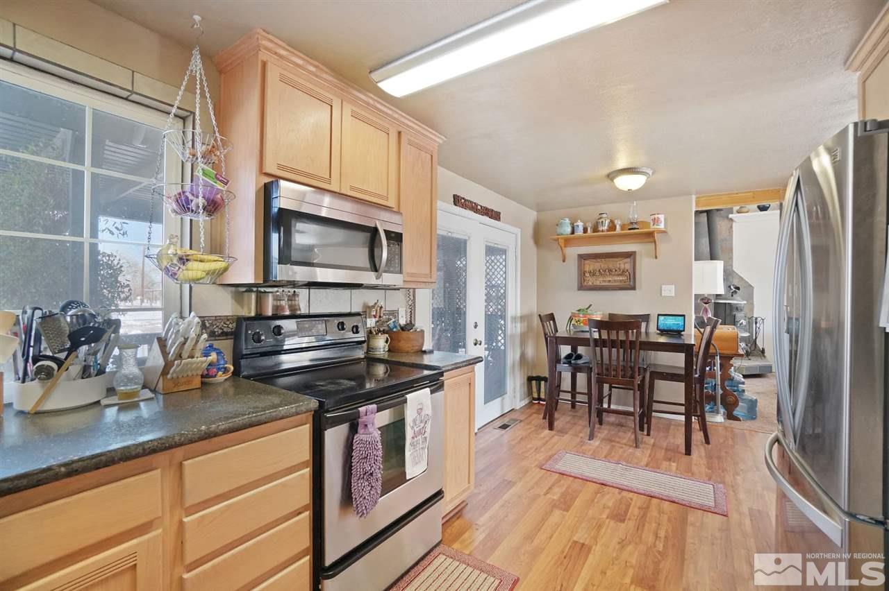 3800 Alcorn Road Fallon, NV 89406 - Photo 7 of 18 a kitchen with stainless steel appliances a stove a sink cabinets and a dining table