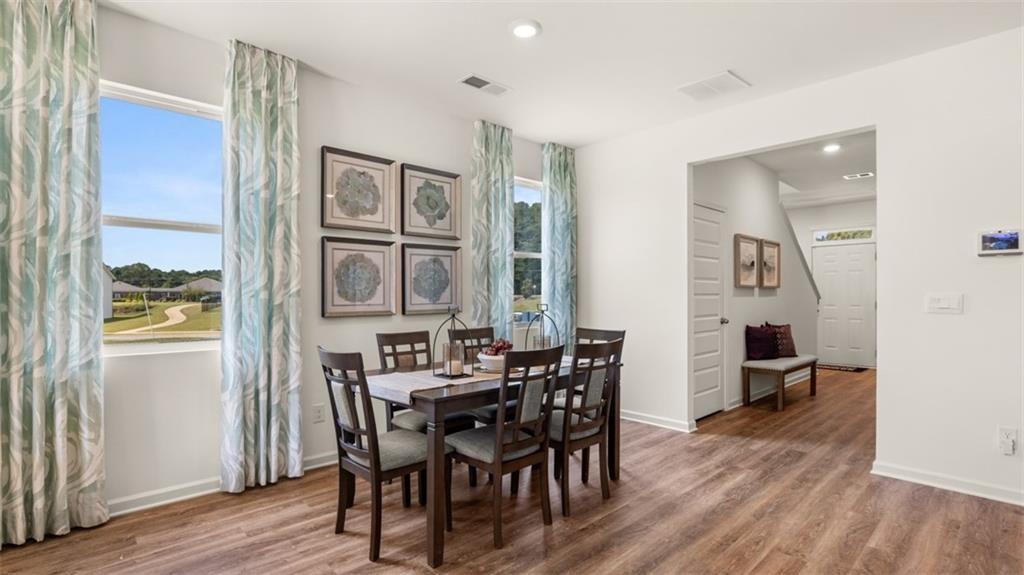 11933 Aukerman Way Hampton, GA 30228 - Photo 14 of 42 a view of a dining room with furniture and wooden floor
