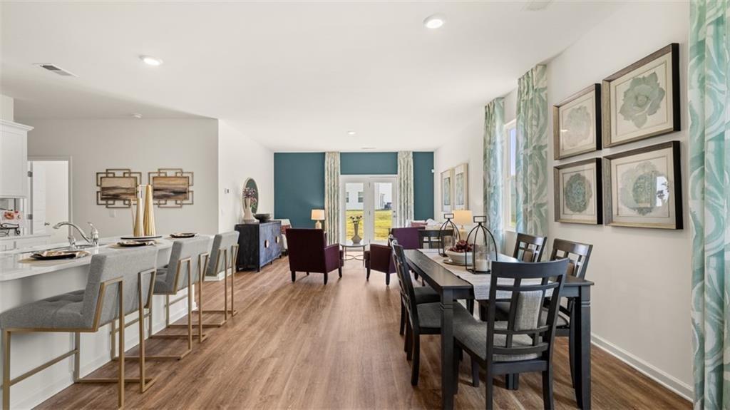 11933 Aukerman Way Hampton, GA 30228 - Photo 15 of 42 a view of a dining room with furniture window and wooden floor