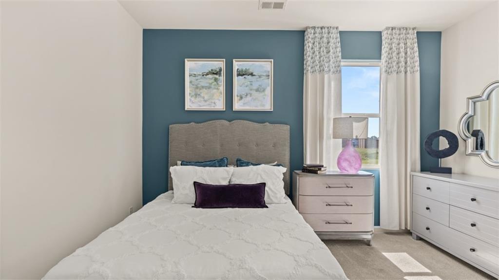 11933 Aukerman Way Hampton, GA 30228 - Photo 20 of 42 a bedroom with a bed and a dresser