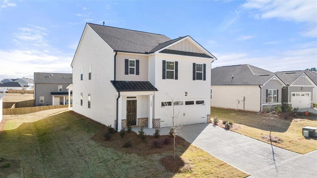 11933 Aukerman Way Hampton, GA 30228 - Photo 2 of 42 a front view of a house with a yard
