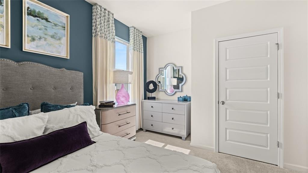 11933 Aukerman Way Hampton, GA 30228 - Photo 21 of 42 a bedroom with a bed and window