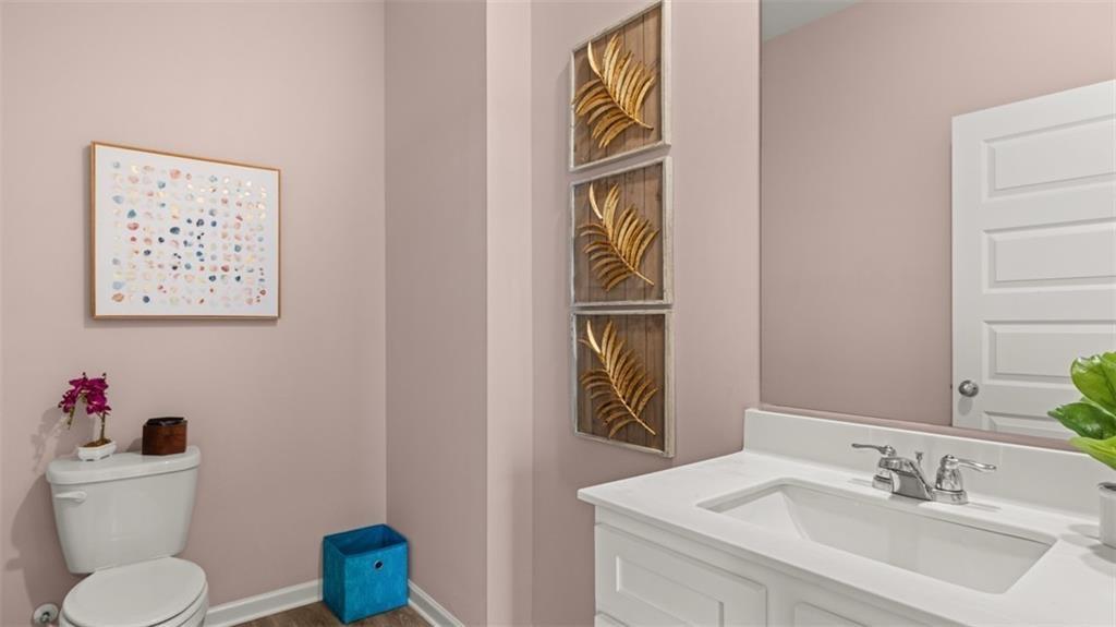 11933 Aukerman Way Hampton, GA 30228 - Photo 22 of 42 a bathroom with a toilet sink and mirror