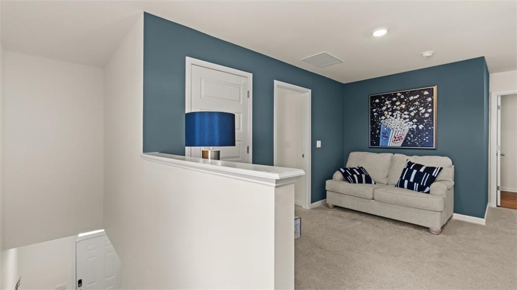 11933 Aukerman Way Hampton, GA 30228 - Photo 24 of 42 a living room with furniture and a table