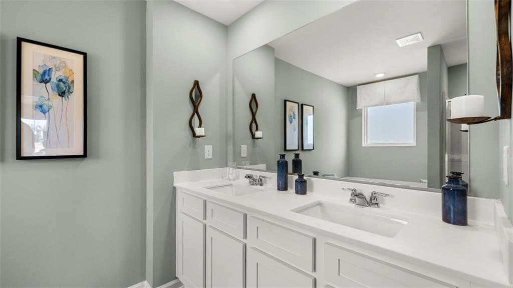 11933 Aukerman Way Hampton, GA 30228 - Photo 32 of 42 a bathroom with double vanity sink and a mirror
