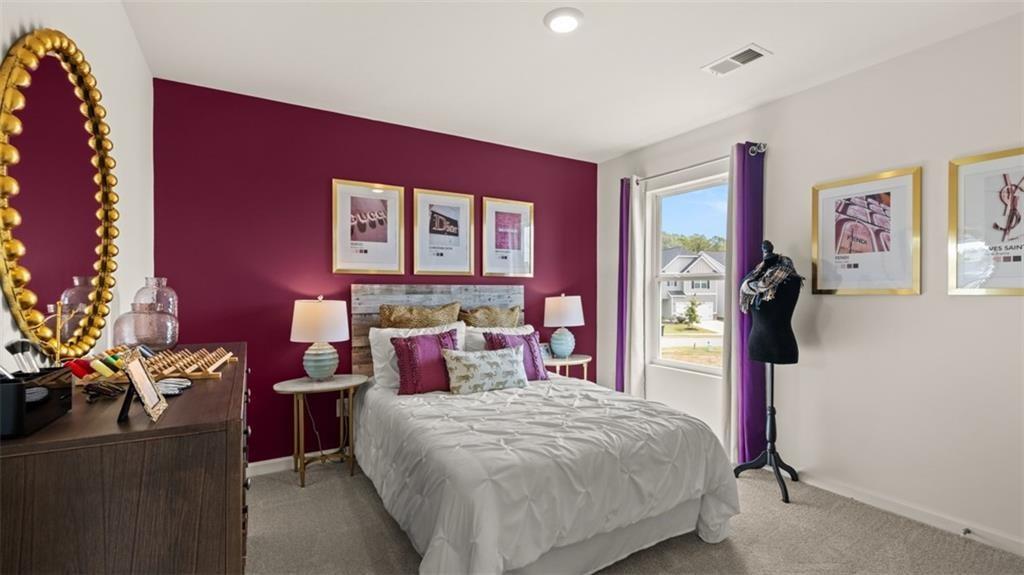 11933 Aukerman Way Hampton, GA 30228 - Photo 37 of 42 a bedroom with a bed and a potted plant