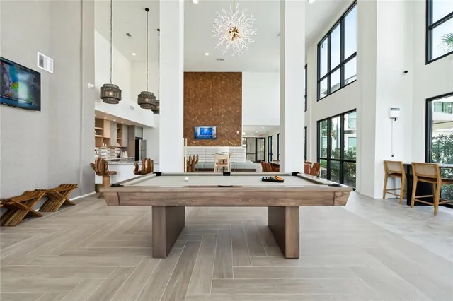 a room with pool table and windows