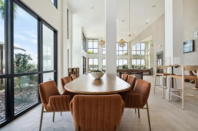 a dining room with furniture window and wooden floor