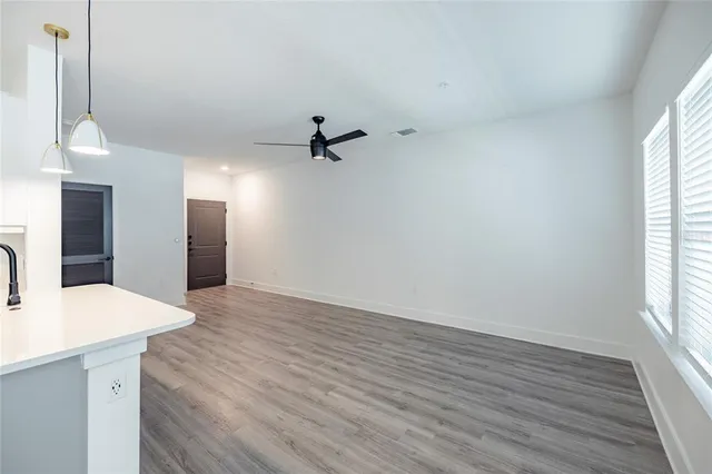 a view of a kitchen cabinets a sink and wooden floor