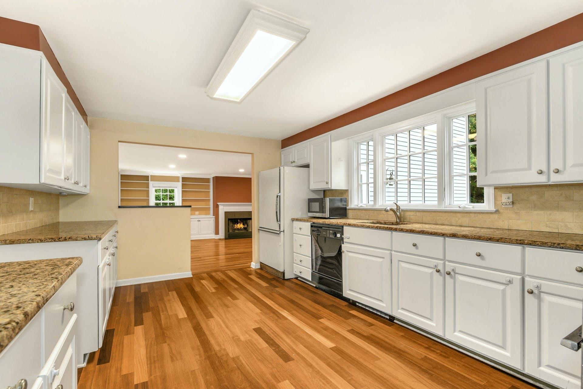 15 Briar Brae Road Darien, CT 06820 - Photo 11 of 32 a kitchen with granite countertop white cabinets and white appliances