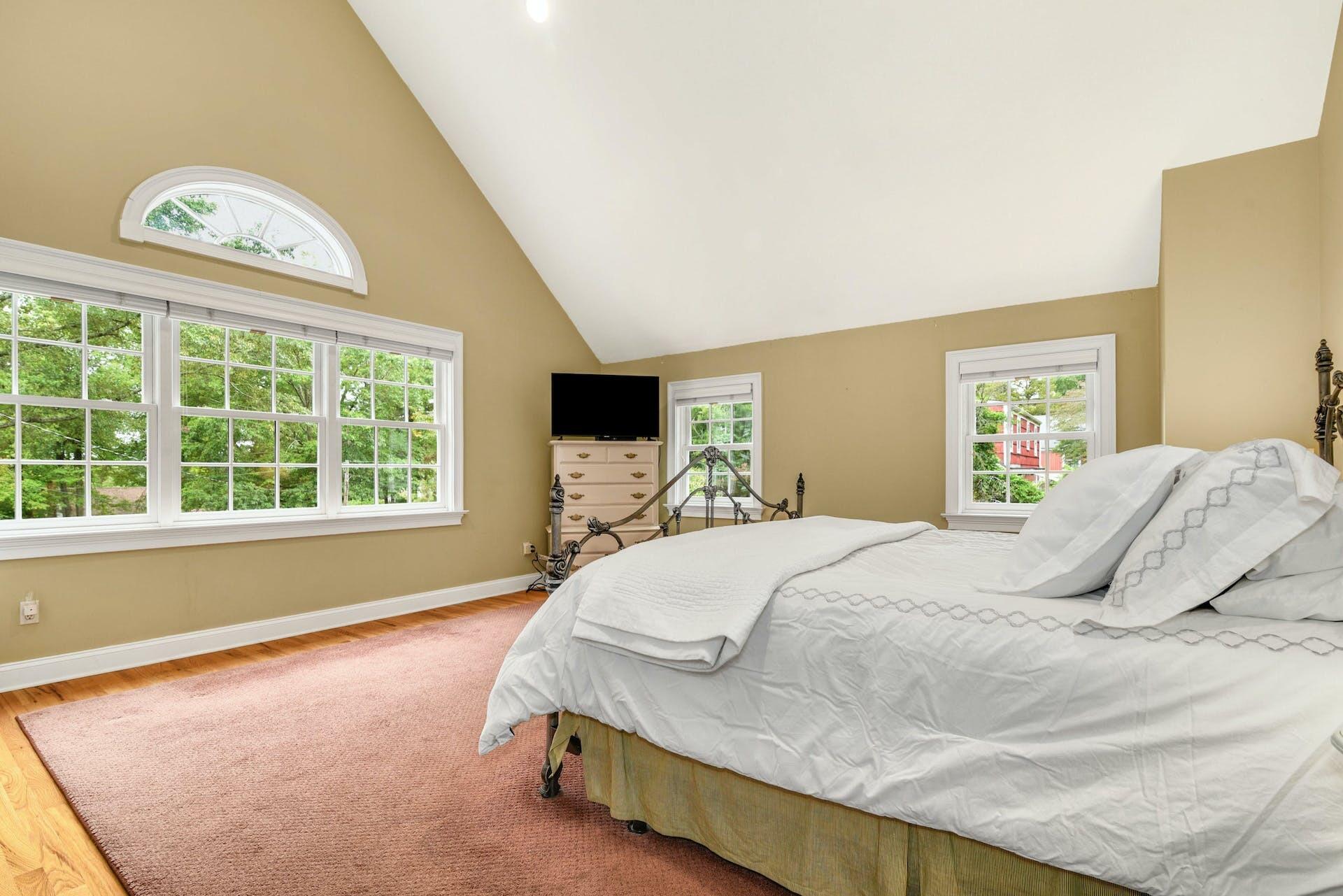 15 Briar Brae Road Darien, CT 06820 - Photo 19 of 32 a bedroom with a bed and a large window