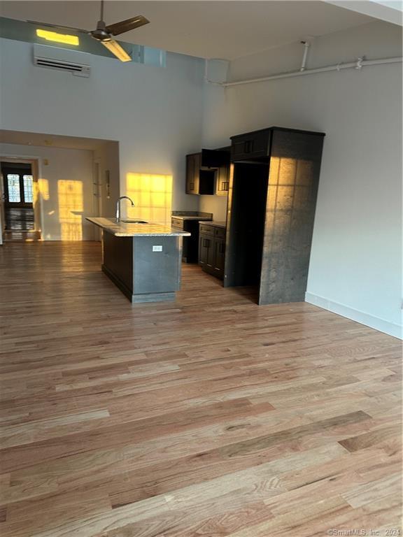3 Banner Road, Unit 110 East Haddam, CT 06469 - Photo 12 of 19 a view of a living room with kitchen island stainless steel appliances granite countertop room