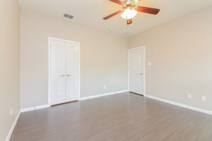 313 Caladium Drive Forney, TX 75126 - Photo 6 of 9 an empty room with a chandelier fan and windows