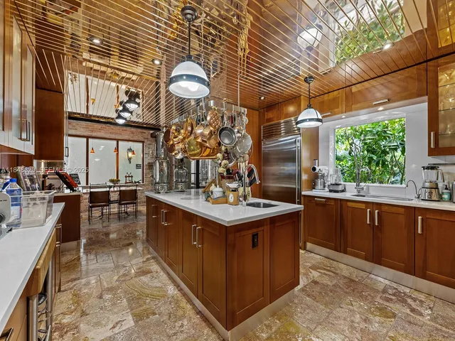 a kitchen with stainless steel appliances granite countertop a sink and cabinets