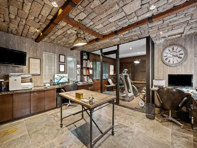 a living room with furniture a flat screen tv and kitchen view