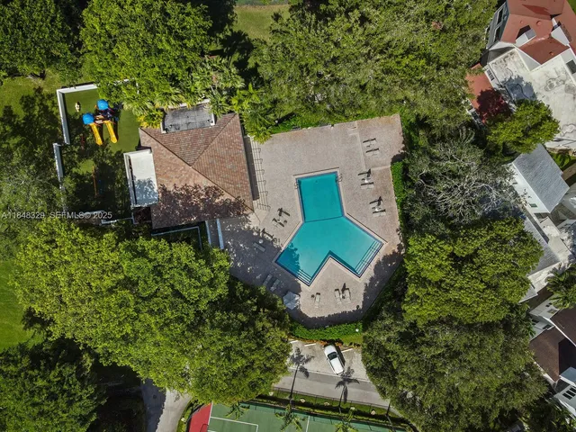 an aerial view of a house with garden space and street view