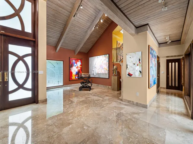 a view of a hallway with wooden floor and windows