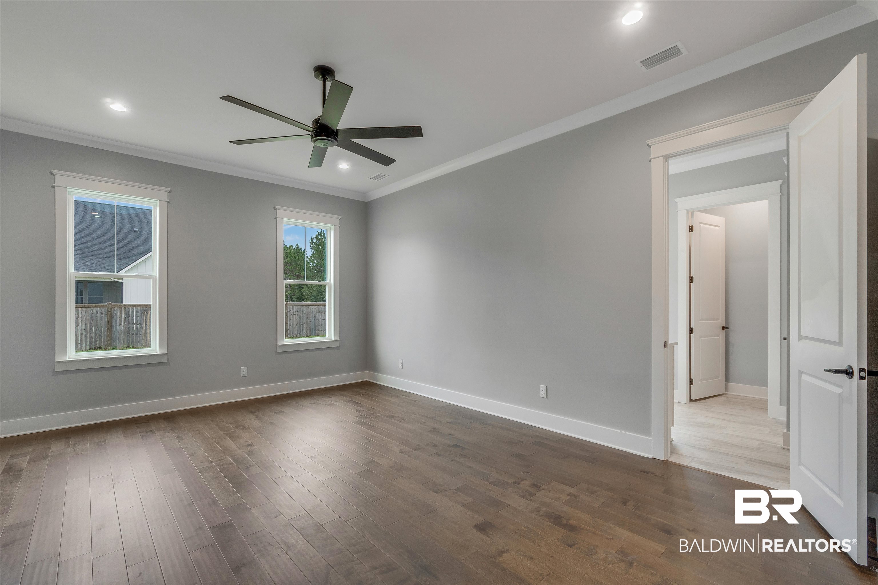 10985 Atrium Avenue Fairhope, AL 36532 - Photo 20 of 58 Empty room with ornamental molding, dark wood-style flooring, recessed lighting, and a ceiling fan