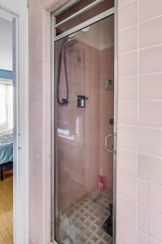 a bathroom with a glass shower door