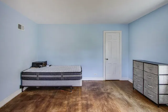 a room with a bed and cabinets