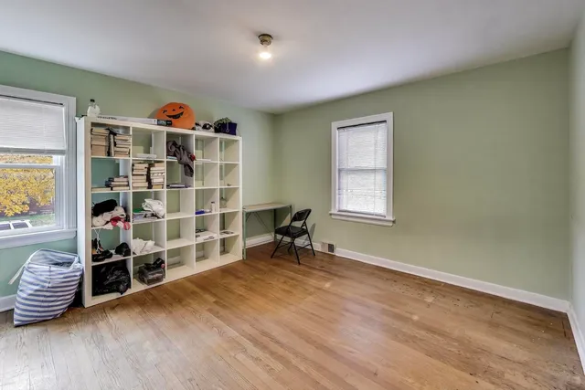 a view of wooden floor and windows in a room