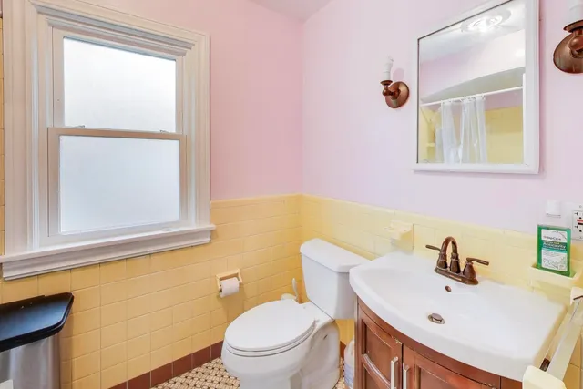 a bathroom with a sink a toilet and mirror