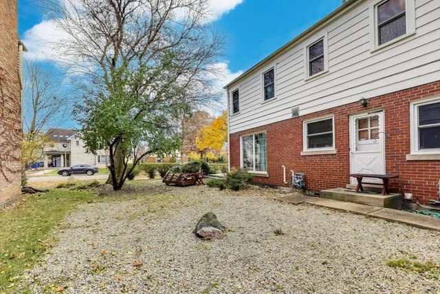 a view of a backyard with a large tree