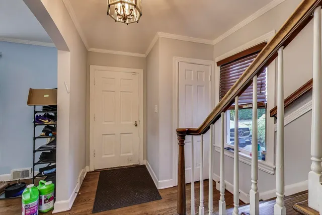a view of an entryway with wooden floor and stairs