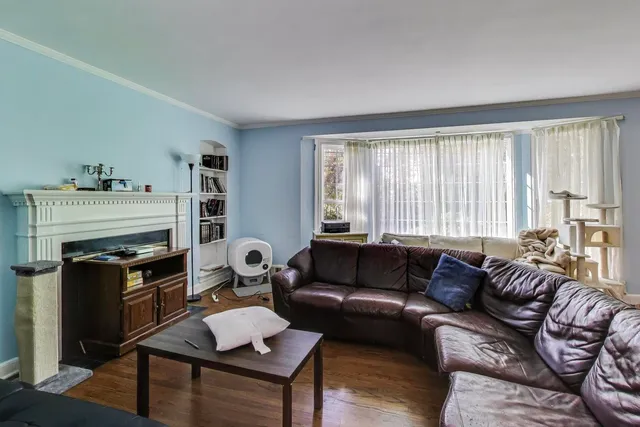 a living room with furniture a fireplace and a window