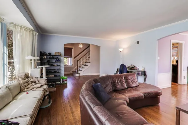 a living room with furniture fireplace and wooden floor