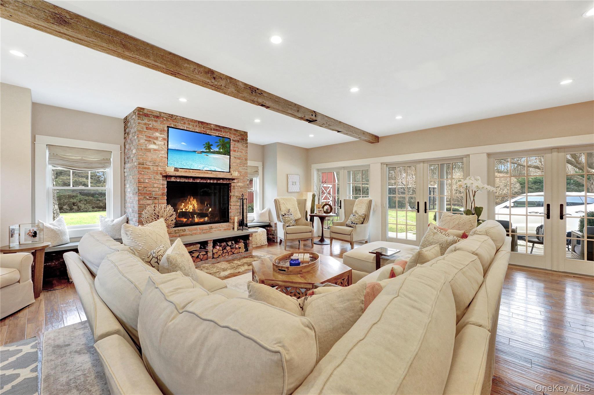 198 South Country Road Remsenburg, NY 11960 - Photo 11 of 49 a living room with fireplace furniture and a flat screen tv