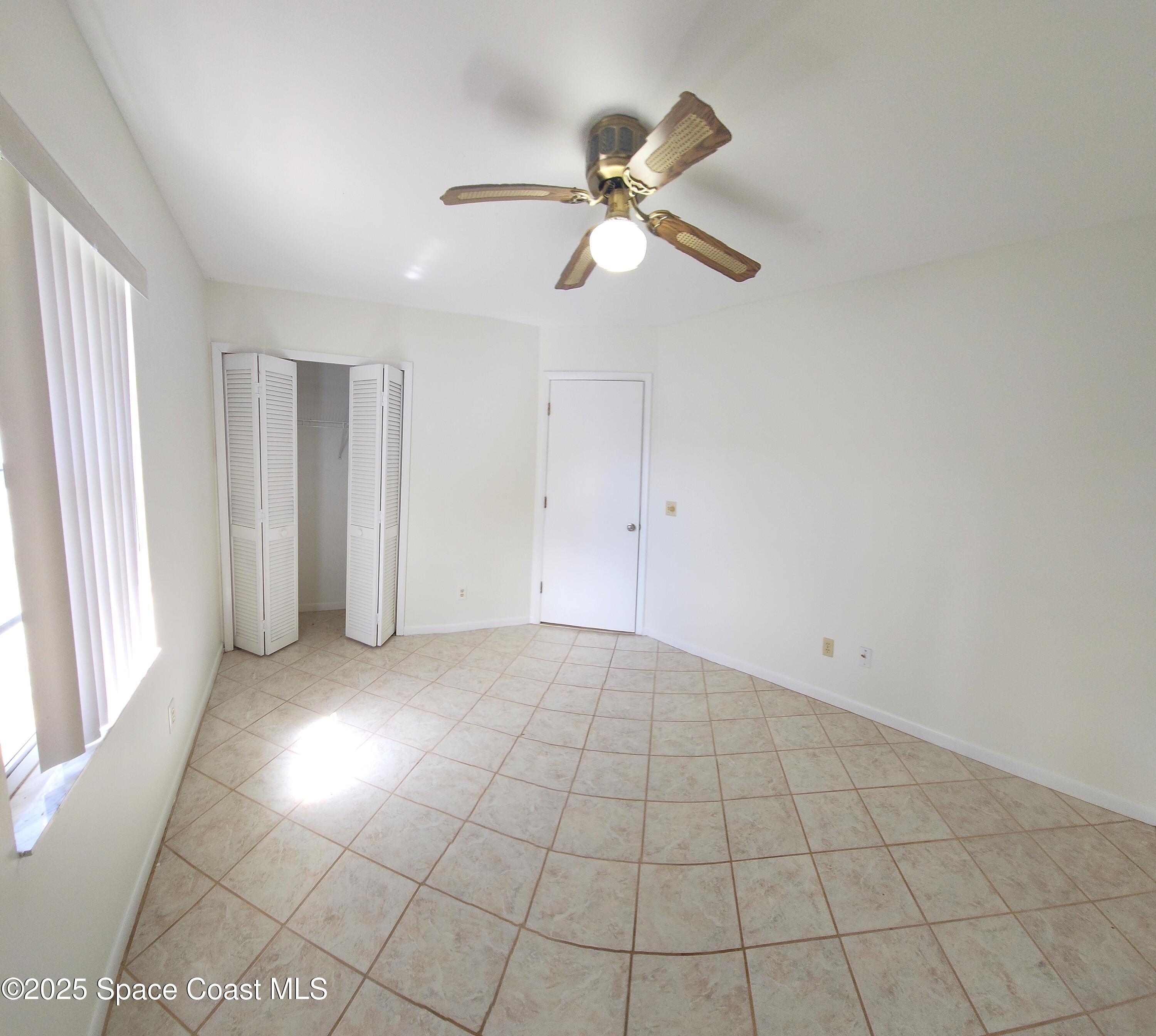 7746 Mango Grove Avenue Melbourne, FL 32904 - Photo 11 of 17 a view of an empty room with a window