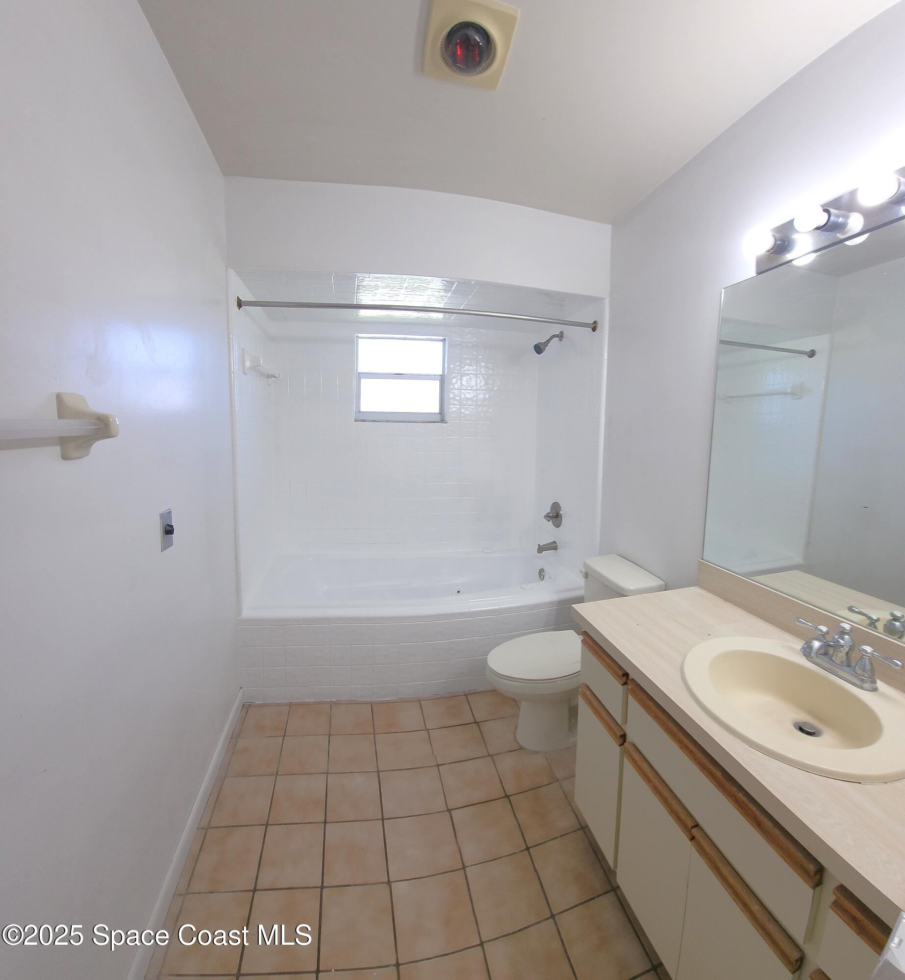 7746 Mango Grove Avenue Melbourne, FL 32904 - Photo 12 of 17 a bathroom with a sink a toilet and shower