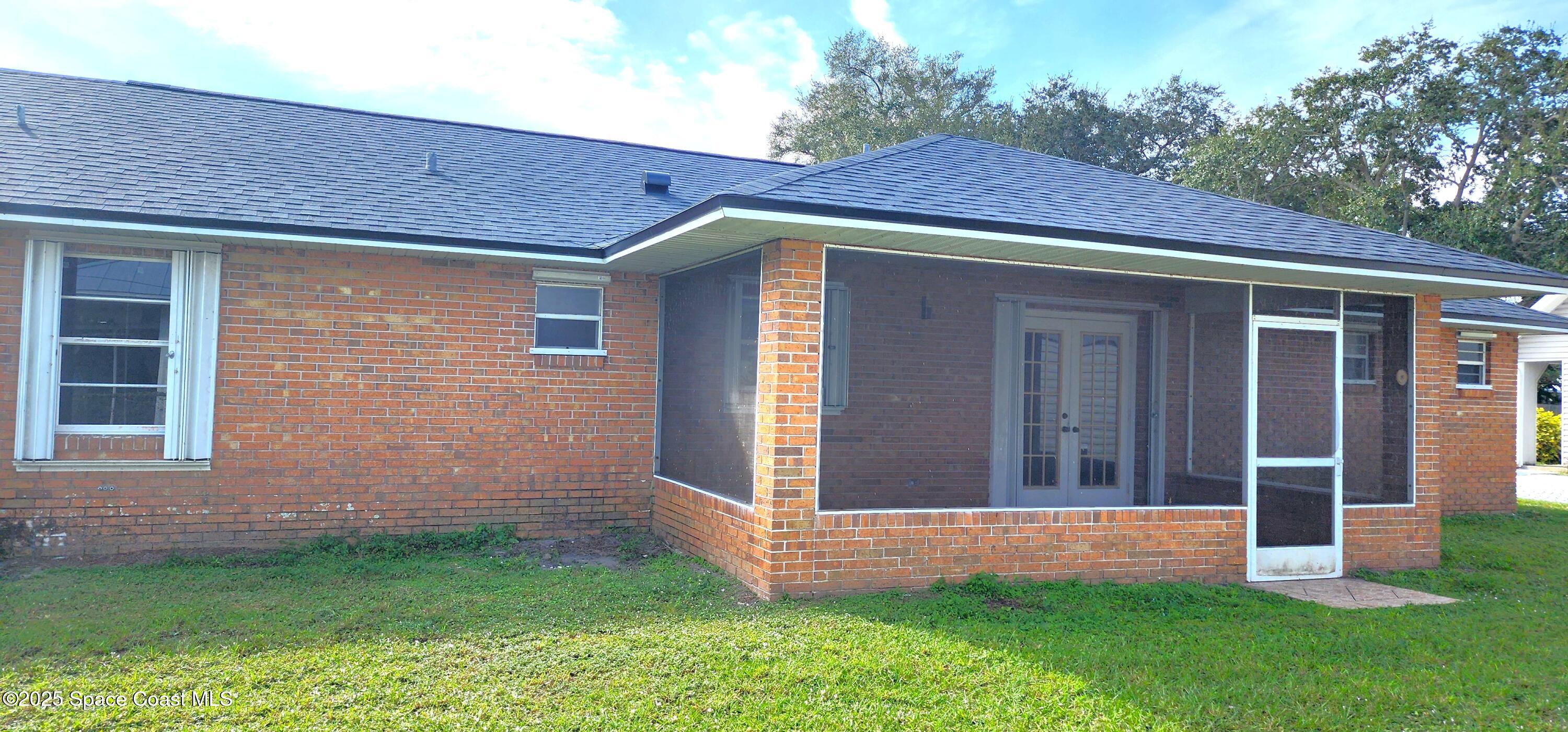 7746 Mango Grove Avenue Melbourne, FL 32904 - Photo 15 of 17 a view of front of a house with a yard