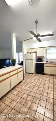 a kitchen with a sink a counter top space cabinets and stainless steel appliances