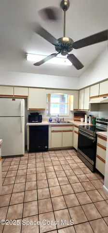 a kitchen with a sink and a stove top oven