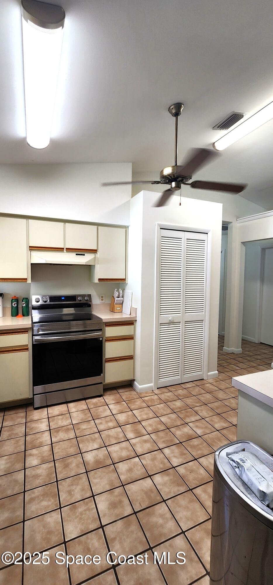 7746 Mango Grove Avenue Melbourne, FL 32904 - Photo 6 of 17 a kitchen with a sink and a stove top oven
