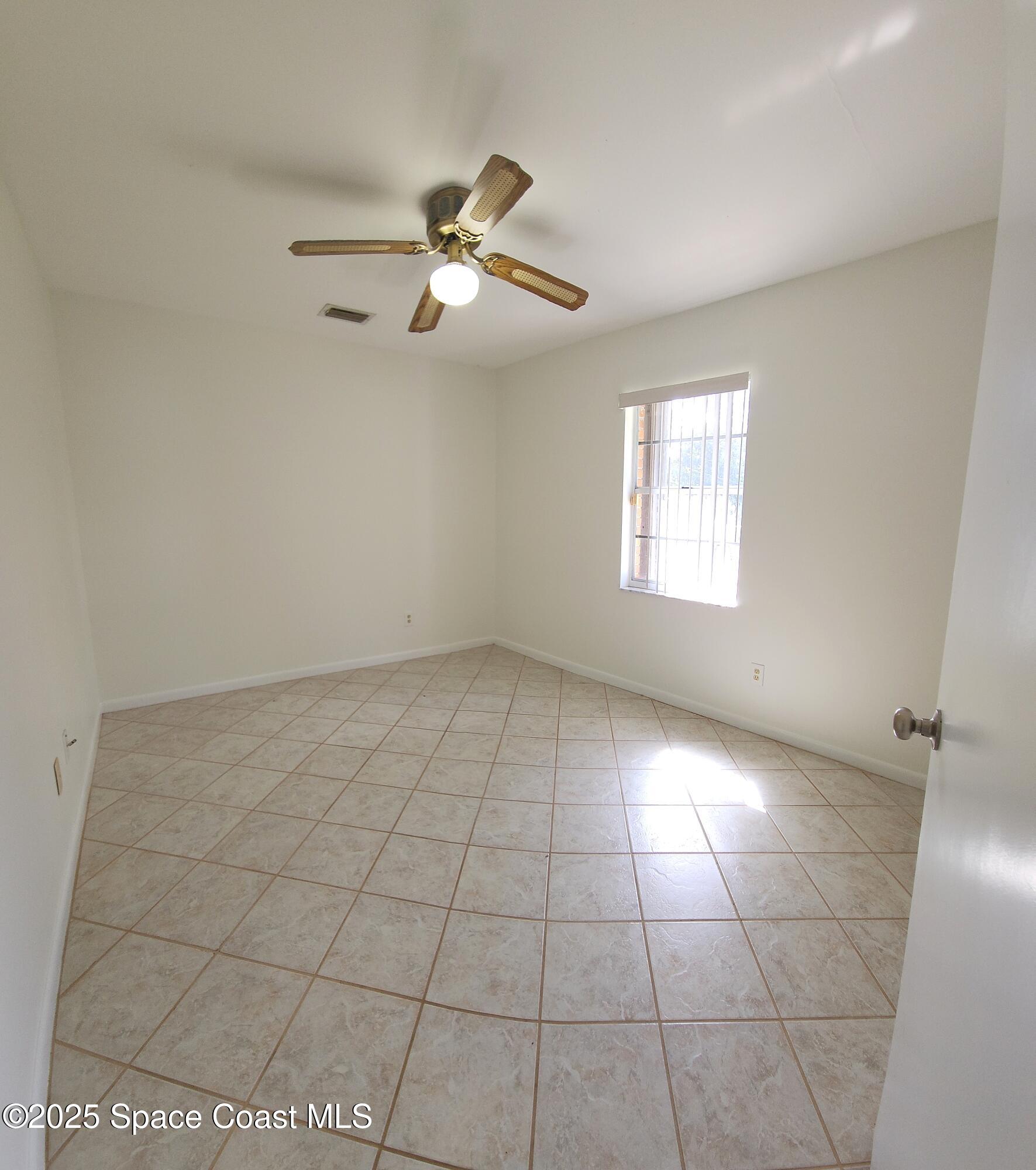 7746 Mango Grove Avenue Melbourne, FL 32904 - Photo 10 of 17 a view of an empty room with a window