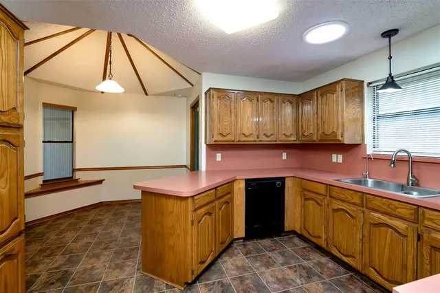 a kitchen with stainless steel appliances granite countertop a sink and a stove