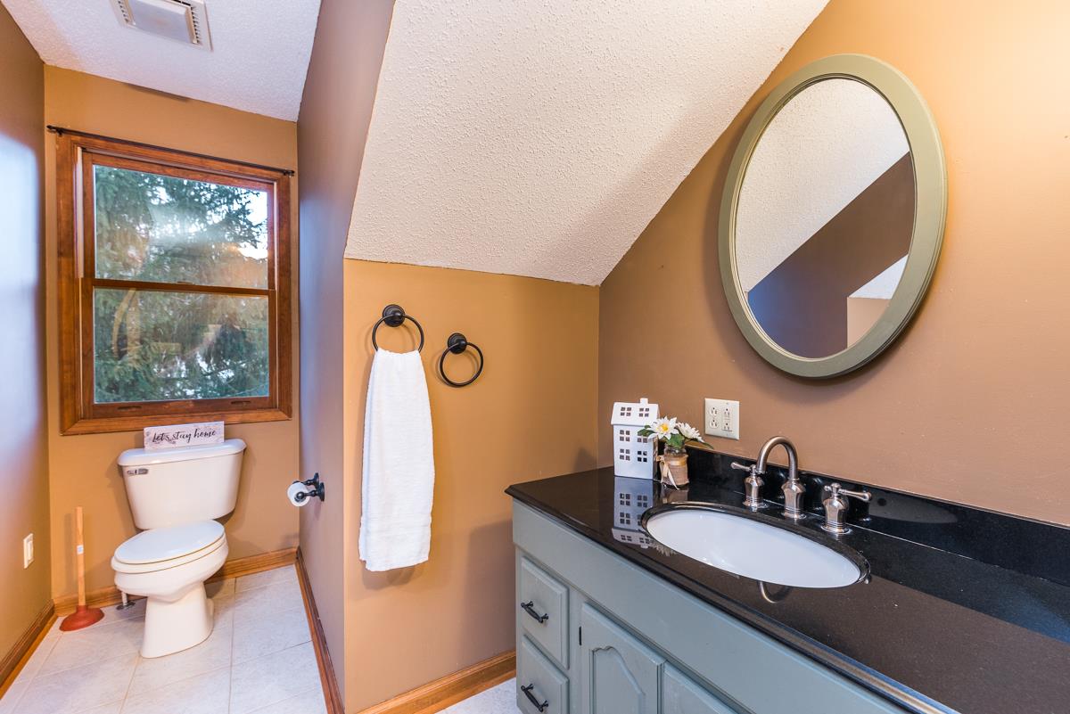 403 Purple Cow Road Waynesboro, VA 22980 - Photo 38 of 50 a bathroom with a granite countertop toilet and a sink