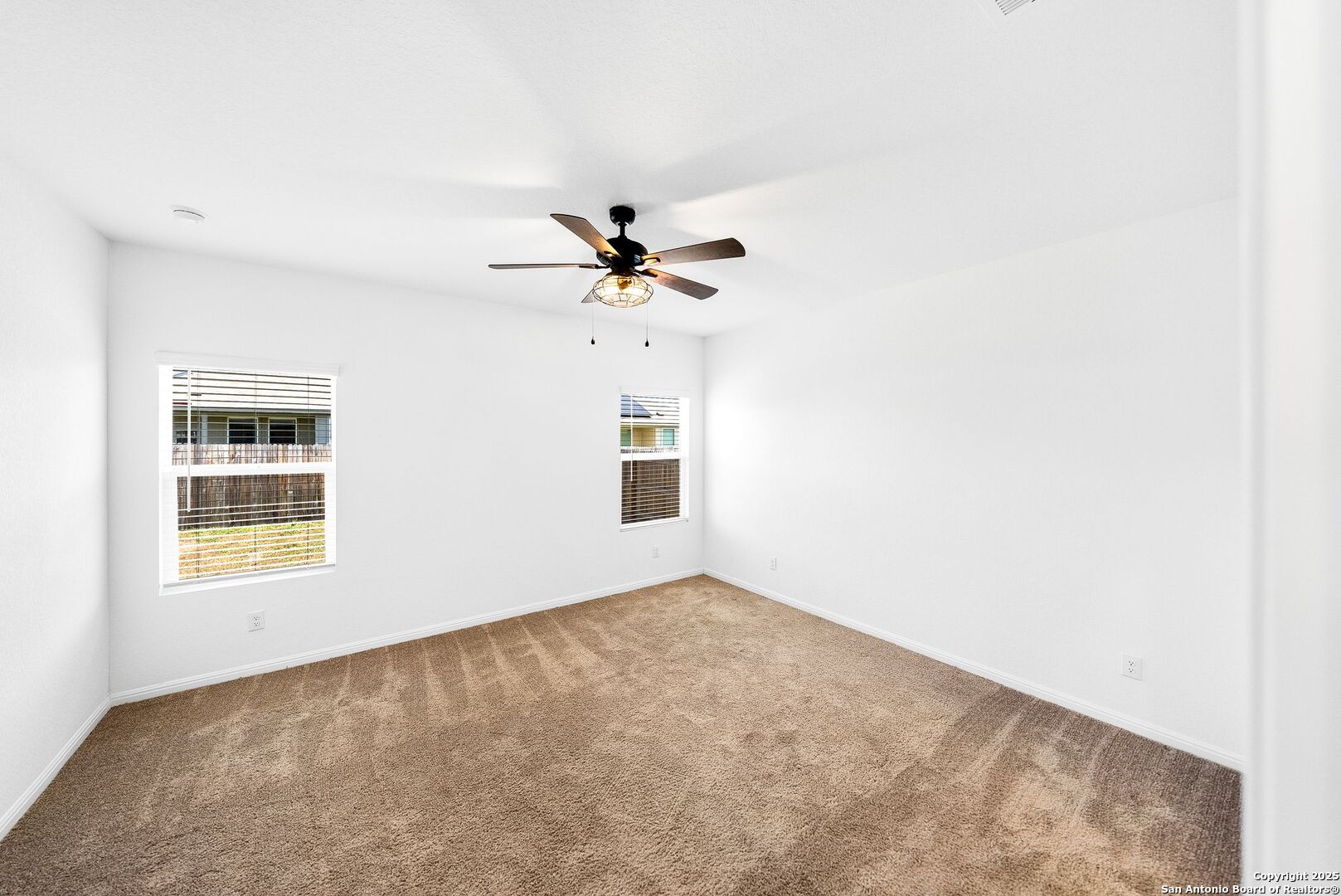 31920 Native Sun Road Bulverde, TX 78163 - Photo 14 of 62 an empty room with windows and fan