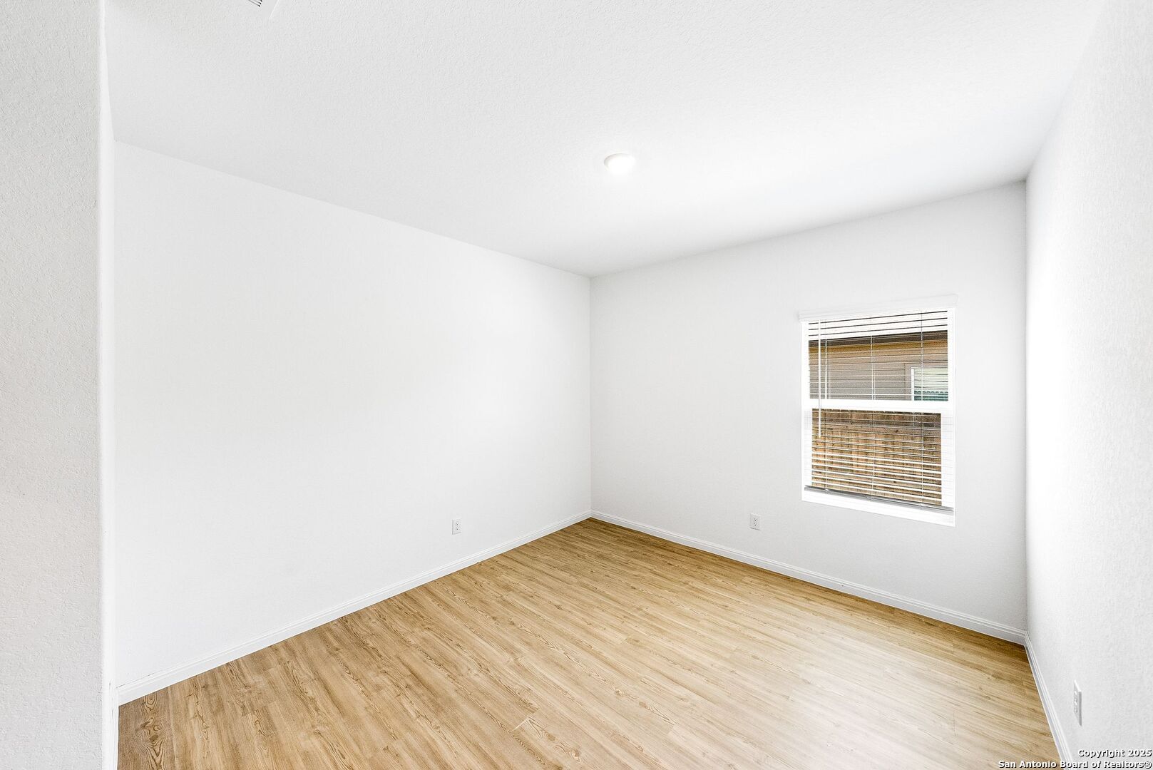 31920 Native Sun Road Bulverde, TX 78163 - Photo 23 of 62 a view of an empty room with wooden floor and a window