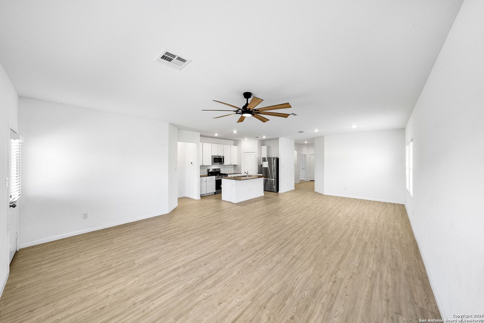 31920 Native Sun Road Bulverde, TX 78163 - Photo 7 of 62 a view of empty room with wooden floor and fan