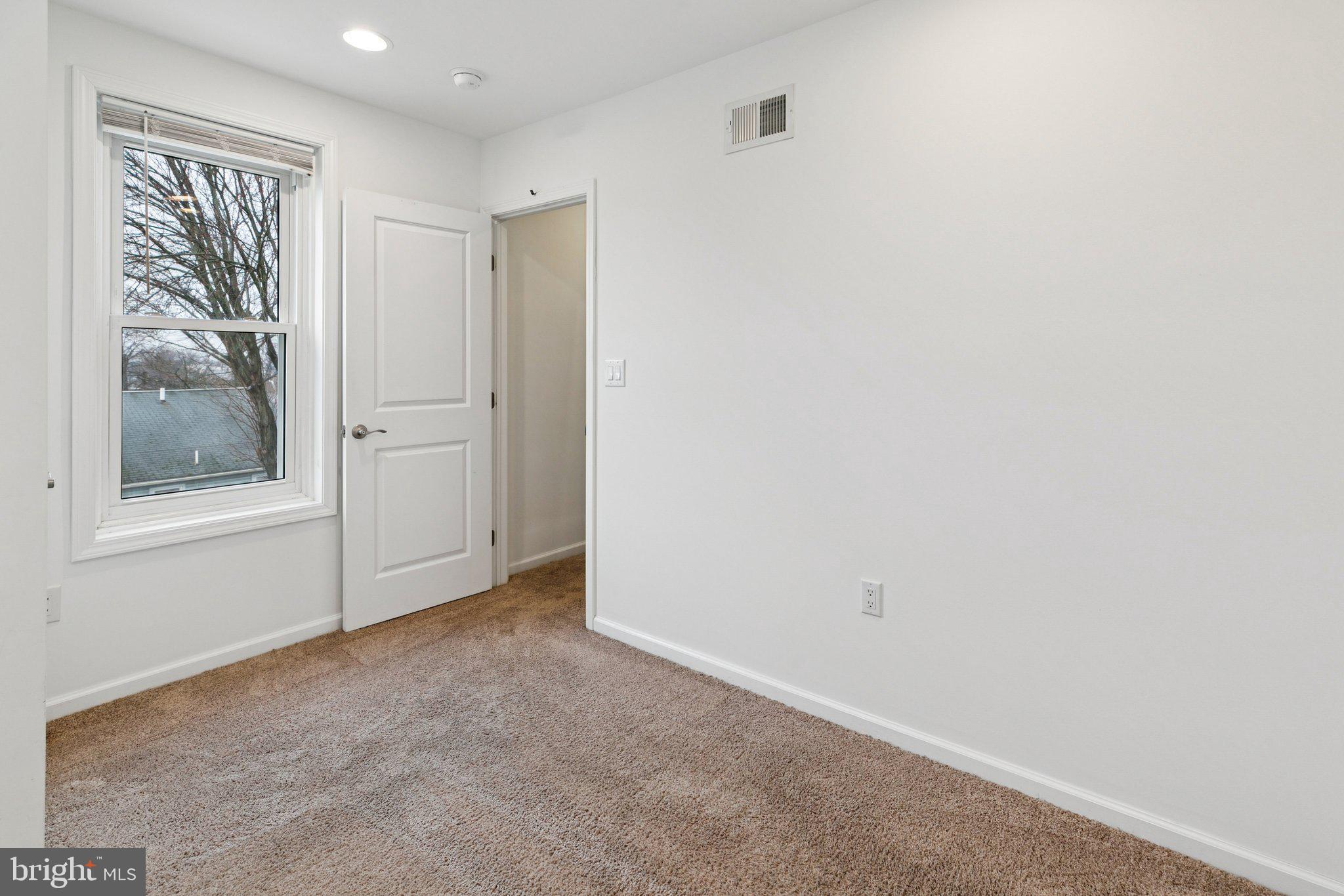 359 Lemonte Street Philadelphia, PA 19128 - Photo 22 of 37 an empty room with windows and closet