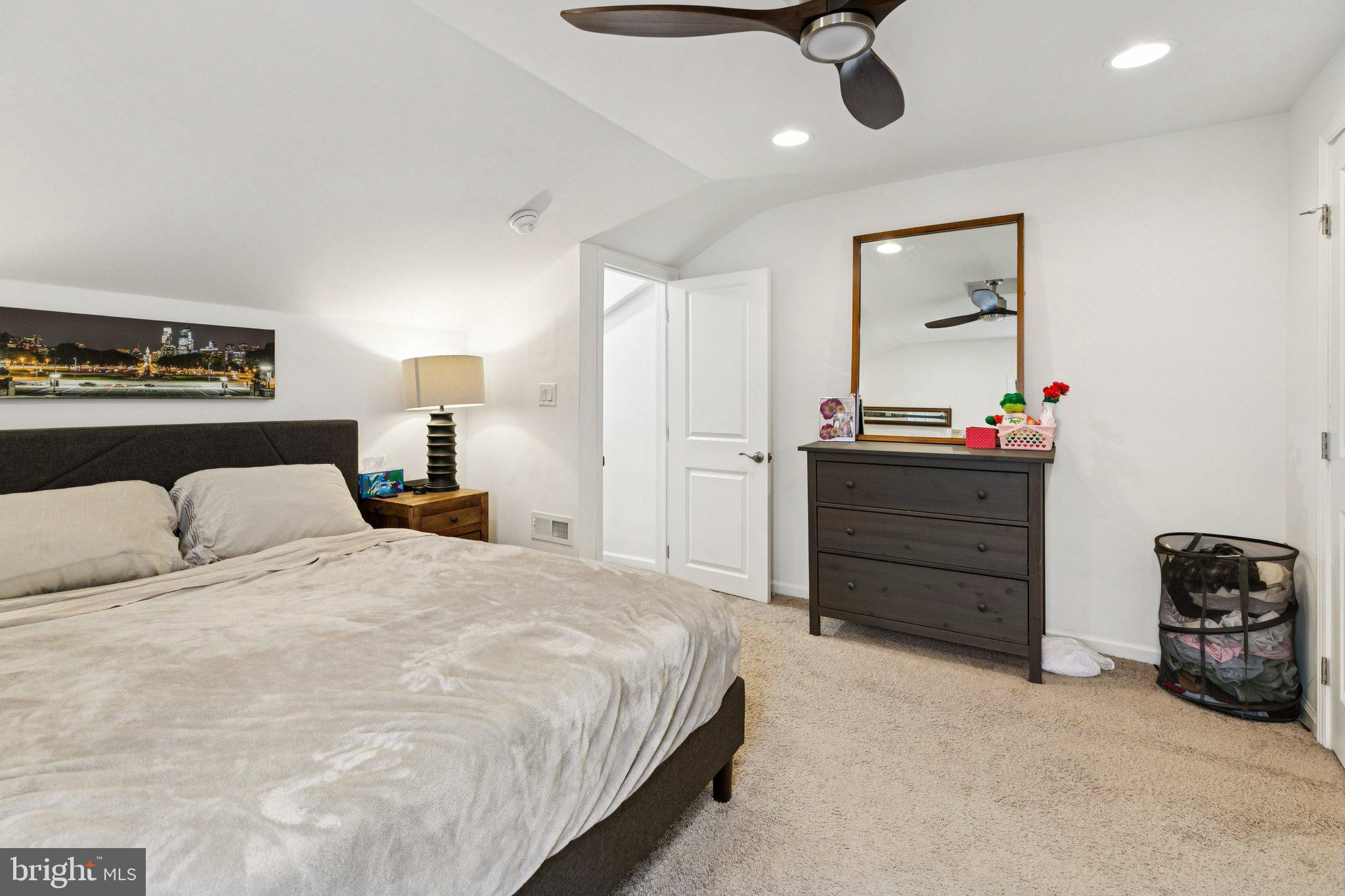 359 Lemonte Street Philadelphia, PA 19128 - Photo 25 of 37 a bedroom with a bed and a chandelier