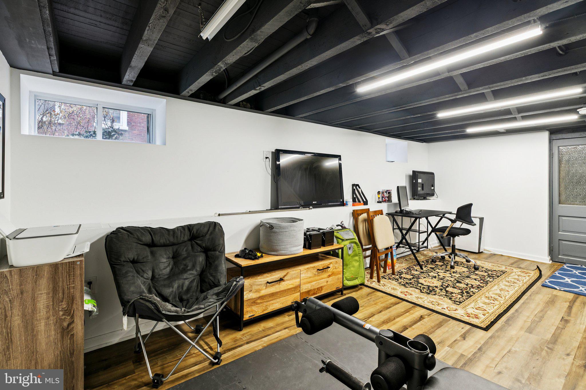 359 Lemonte Street Philadelphia, PA 19128 - Photo 34 of 37 a living room with furniture and a flat screen tv