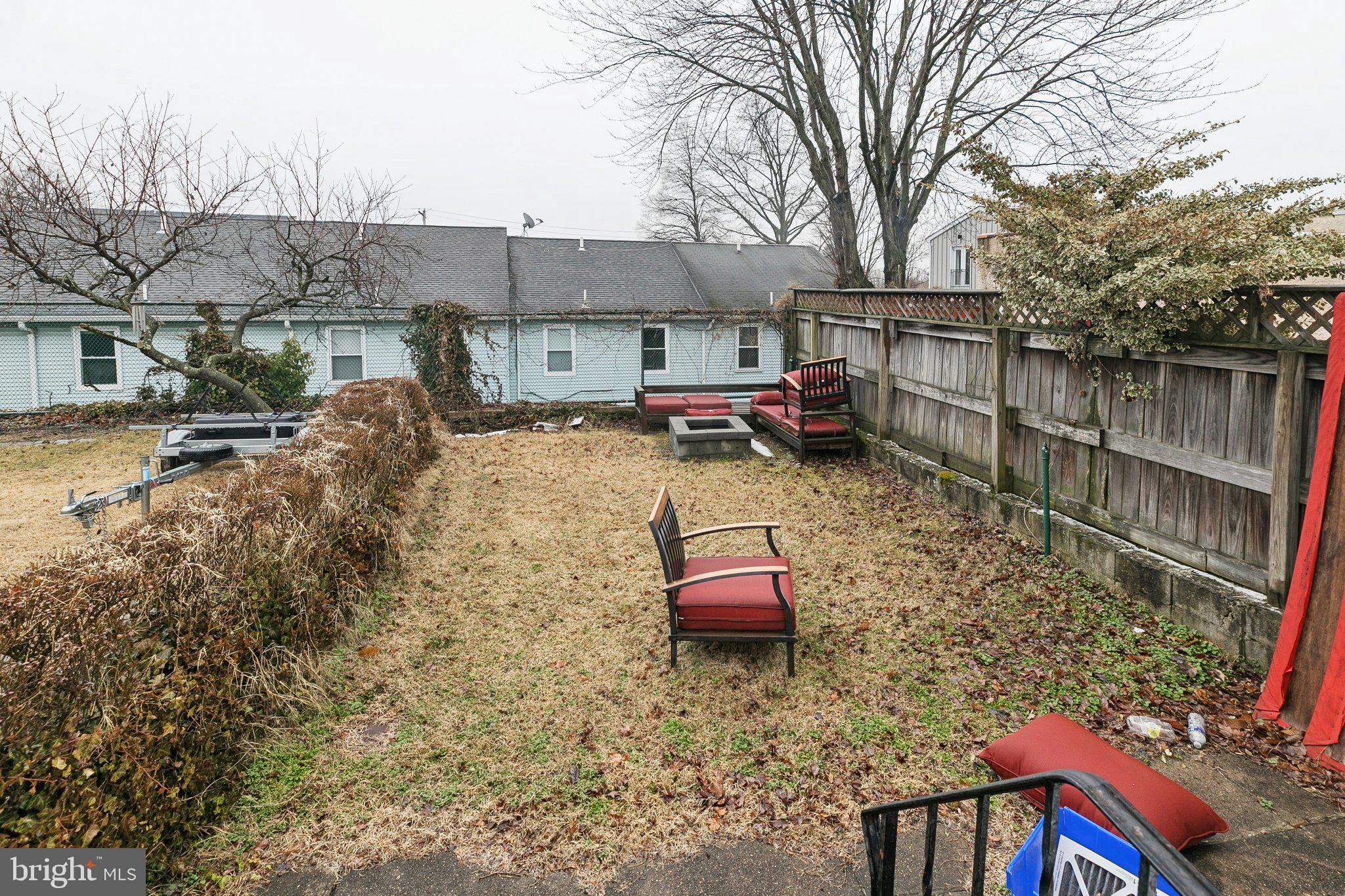 359 Lemonte Street Philadelphia, PA 19128 - Photo 36 of 37 a backyard of a house with fire pit and chairs