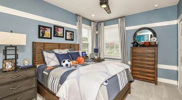 a bedroom with a bed and a chandelier