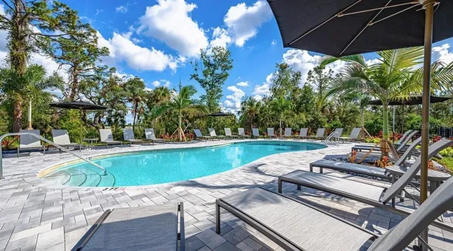 a view of a swimming pool with outdoor seating